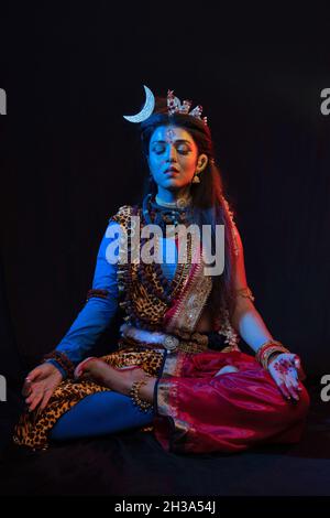 Indian female model  in Ardhanarishvara makeup costume, a composite male-female figure of the Hindu god Shiva together with his consort Parvati. Stock Photo