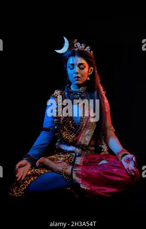 Indian female model  in Ardhanarishvara makeup costume, a composite male-female figure of the Hindu god Shiva together with his consort Parvati. Stock Photo