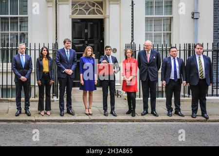 Westminster, London, UK, 27th Oct 2021. Rishi Sunak, Chancellor of the Exchequer, poses outside 11 Downing Street with the iconic red box on Budget Day with members of the Treasury team. Credit: Imageplotter/Alamy Live News