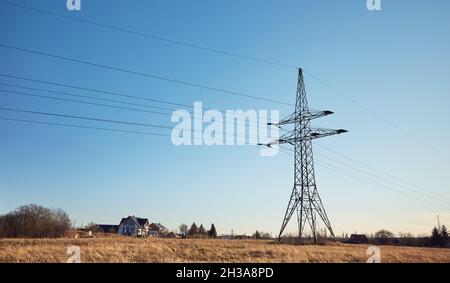 High voltage transmission tower on a field. Stock Photo