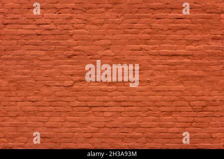 seamless texture and full frame background of brick wall covered with matte orange plaster Stock Photo