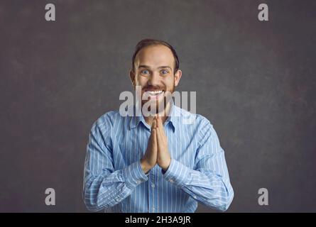 Emotional happy adult man joyfully claps his hands in a sign of finally achieved goal. Stock Photo