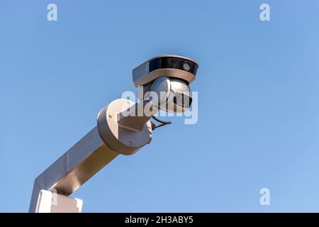 Street surveillance camera on sky background. Stock Photo