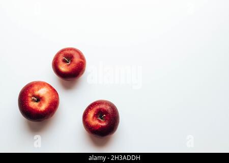 Three ripe juicy red rayal gala apples on grey backgroung. Top view. Autumn composition. Flat lay, top view, copy space Stock Photo