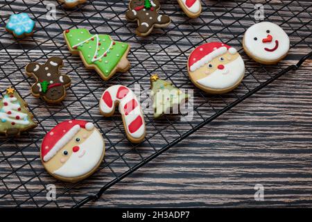 Sugar coated biscuits and Christmas theme cookies on a baking rack with Christmas ornaments. Stock Photo