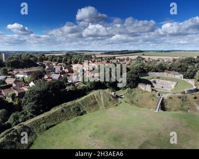 aerial landscape image of a ruined medieval building in the village of Castle Acre Norfolk England Stock Photo