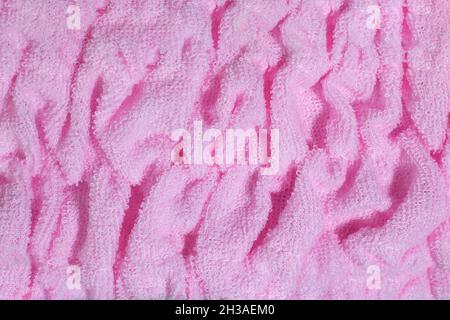 Pink textile terry background. Terry towel or bathrobe close up. Stock Photo