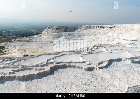 Travertine terrace formations in Pamukkale, Turkey. The area is famous for a carbonate mineral travertines left by the flowing of thermal spring water Stock Photo