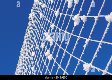 Volleyball net covered with snow. Nature's minimalism.  Stock Photo