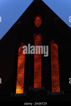 Windows of all Souls Church, St Margarets, lit at night, England Stock Photo