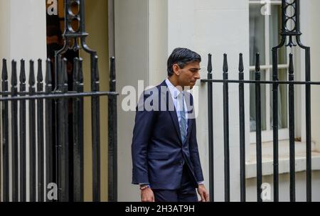 Downing Street, London, UK. 27th Oct, 2021. Rishi Sunak, Chancellor of the Exchequer, leaves the front door of 11 Downing Street before standing for the traditional press photoshoot with his red Budget box containing the speech he will bring to Parliament giving his Autumn Budget Statement on financial policy. Credit: Malcolm Park/Alamy Stock Photo