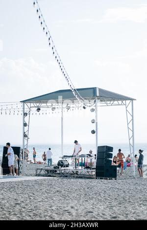SEVA, ARMENIA - Sep 03, 2021: A group of young people enjoying the beach party on the shore of Lake Sevan, Armenia Stock Photo