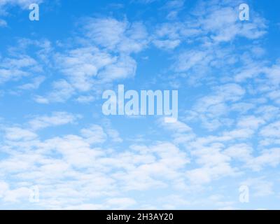 many small light clouds in blue sky on sunny autumn day Stock Photo