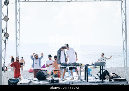 SEVAN, ARMENIA - Sep 03, 2021: A group of young people enjoying the beach party on the shore of Lake Sevan, Armenia Stock Photo