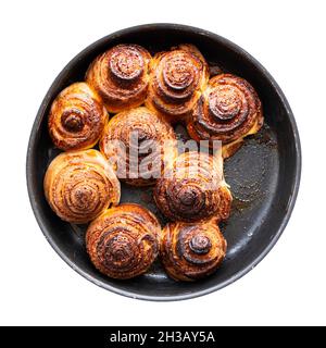 top view of homemade fresh baked cinnamon buns in round baking dish cutout on white background Stock Photo