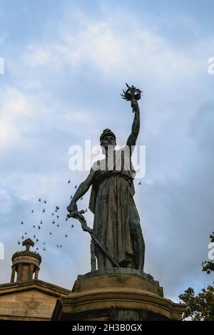 Street scene with sculpture on the Plainstones. High Street, Royal Burgh of Elgin, Moray, Scotland, UK, Britain Stock Photo