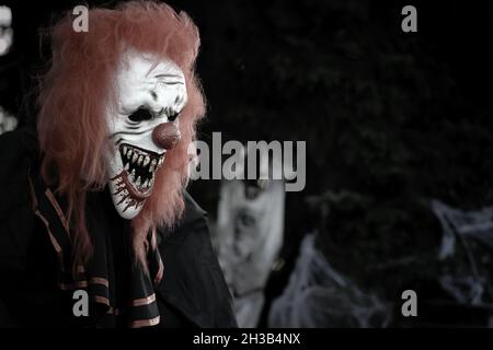 Scary creepy clown decoration at night during Halloween Stock Photo