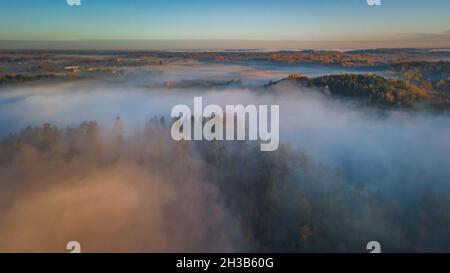 Aerial view of epic fog over the forests at Autumn Stock Photo