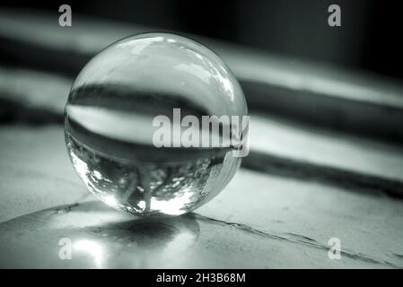 Monochrome image of a lens ball on an old window sill Stock Photo
