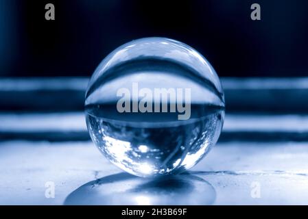 Monochrome image of a lens ball on an old window sill Stock Photo
