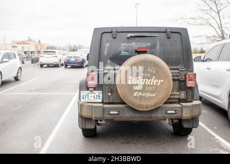 2019 01 12 Tulsa OK USA Dark dirty off road jeep parked in parking lot with wheel cover reading All Who Wander are Not Lost - Life is Good Stock Photo