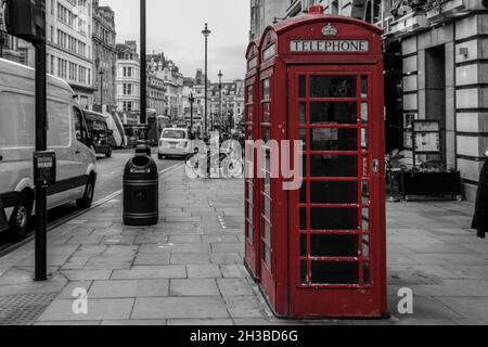 Selective color shot of telephone booths in a grayscale composition of Kingston upon Thames, the UK Stock Photo