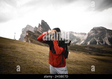Man in red jacket taking photos Stock Photo