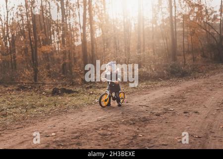 Small tired and overwhelmed boy screaming in forest while sittin Stock Photo