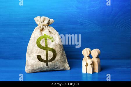 Family figurines and dollar money bag. Social policy, family budget. Investment in human capital. Favorable conditions for population growth. Medicine Stock Photo