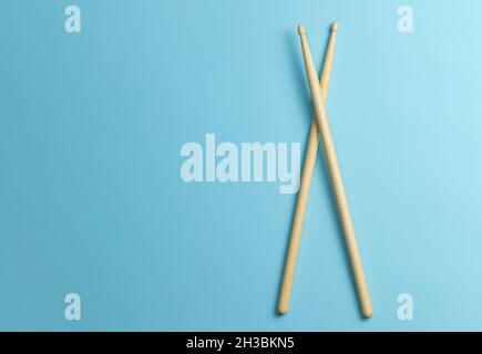 Drum sticks on a blue background. Template Copy space for text. Stock Photo