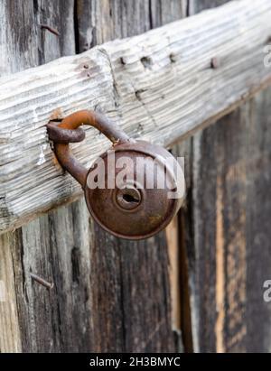 Old iron padlock on a wooden door. Stock Photo