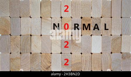 Symbol of covid-19 normal in 2022. Wooden blocks with words 'normal 2022'. Beautiful wooden background, copy space. Medical, covid-19 normal in 2022 c Stock Photo