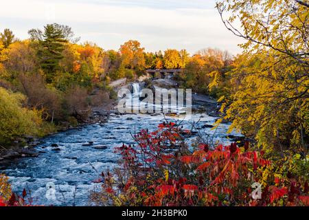 The Hog's Back Falls and Bridge, Prince of Wales Falls waterfalls on the Rideau River in Ottawa city of Canada in autumn. Colorful nature in park with Stock Photo
