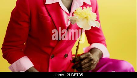 A fashion black man is holding a flower Stock Photo