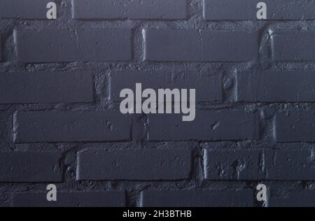 The photo shows a black clinker wall that can be used as a background Stock Photo