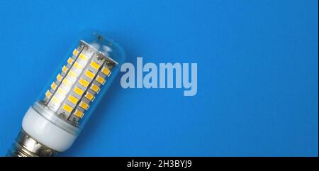 LED light bulb, blue background. Flat lay, top view, copy space photo Stock Photo