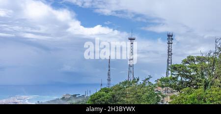 A row of telecommunication towers along Mount Erice in Sicily, Italy. Mount Erice is high above sea level and here overlooks the town of Trapani. Stock Photo