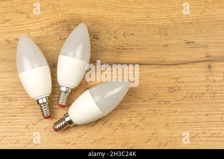 Energy saving, eco friendly LED light bulbs, wooden table background Stock Photo