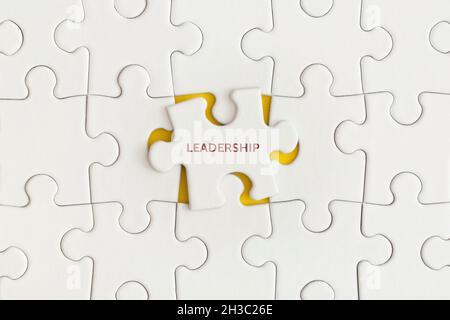 White details of puzzle on yellow background. Business strategy, teamwork. Top view with copy space. Flat lay. Stock Photo