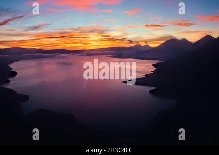 Sunrise over Lake Atitlan with Fuego, Acatenango, Toliman, and Atitlan volcanoes, Lago Atitlan, Guatemala Stock Photo