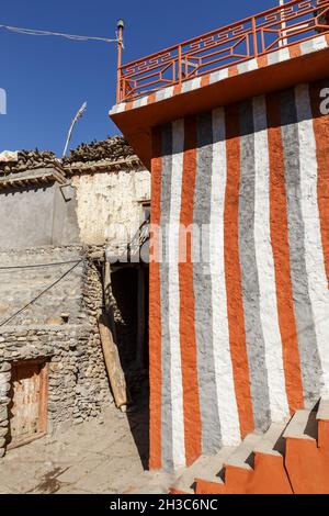 Striped house wall. Entrance to the famous red house lodge in the village of Kagbeni. Lower Mustang. Nepal Stock Photo