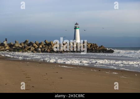 The Walton Lighthouse and concrete tetrapods at the Santa Cruz harbor breakwater. California, USA Stock Photo