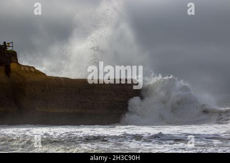Wave crashing into a rocky coastal headland during a storm at Blacks Beach, Santa Cruz , California Stock Photo