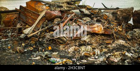 Metallic remnants after a garbage fire Stock Photo