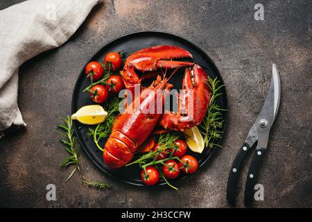 Delicious freshly cooked lobsters on black plate Stock Photo