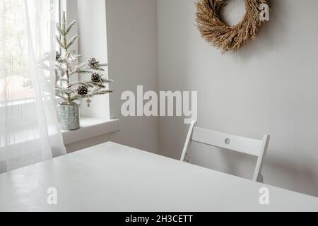Floral dried wreath hanging on white wall in a room Stock Photo