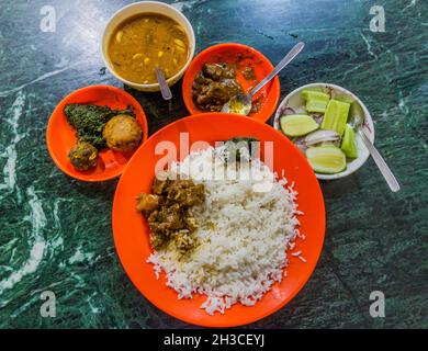 Meal in Bangladesh - Rice, Alo vorta, dhal, Shim borta and chicken curry Stock Photo