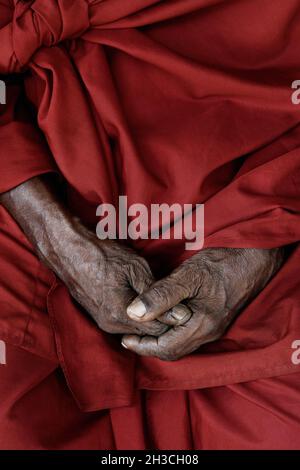 A sadhu holy man rests his hands in his lap in Kerala, India. Stock Photo