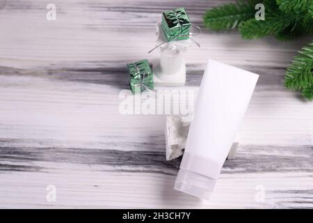 Mockup for body care products. Travel white tube for cream without label. Christmas skin care mockup. Stock Photo