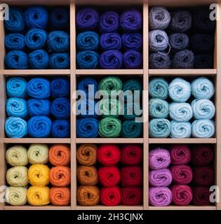 Colorful balls of yarn in shop display. Multi-color wool. Handcraft and handmade background concept. Stock Photo